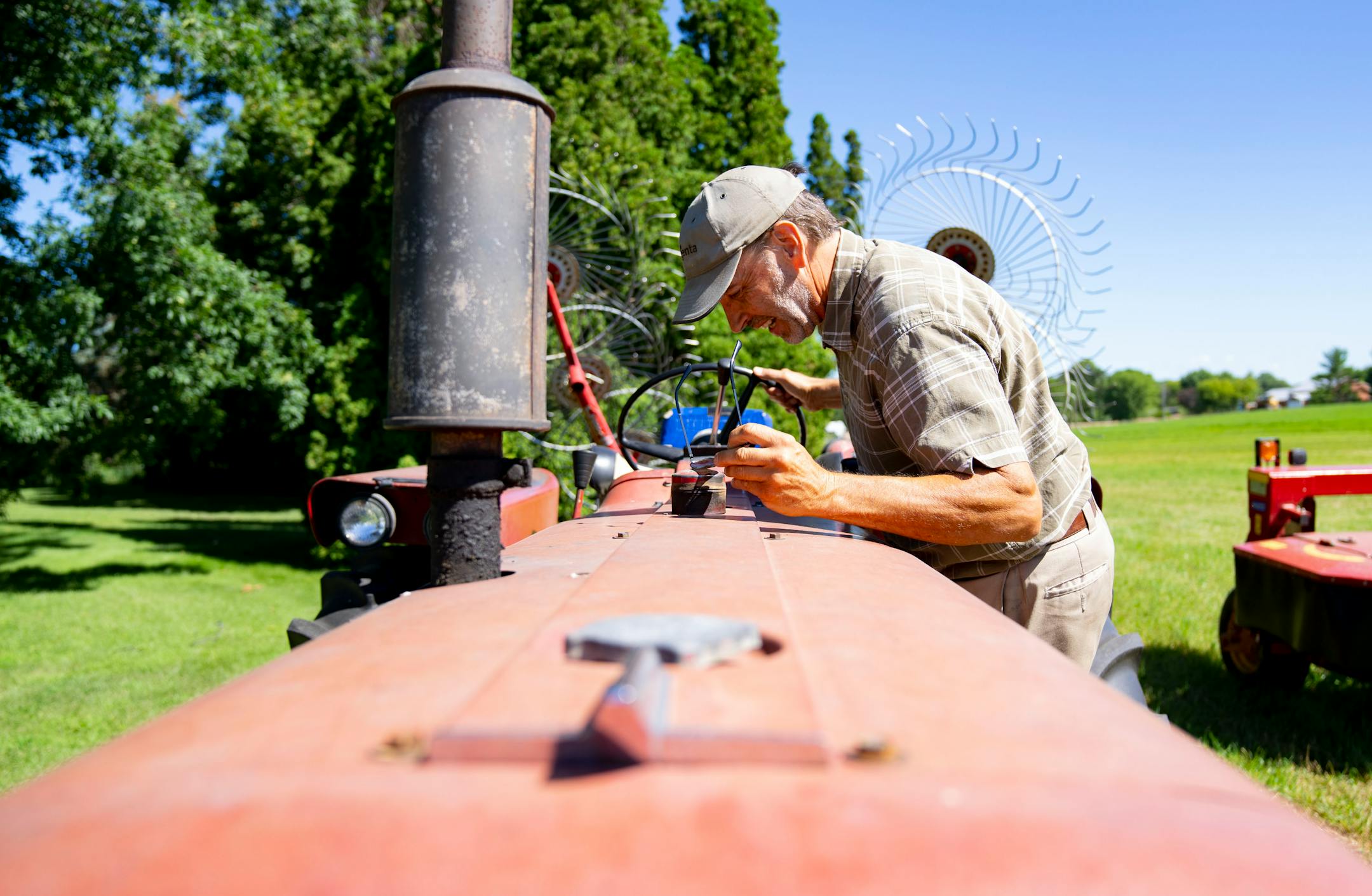 Max Gustafson checks how much fuel he has in his tractor.