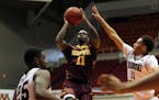 Minnesota guard Carlos Morris, center, goes to the basket against Missouri St. guard Jarred Dixon, right, and teammate Jordan Martin, during the Puert