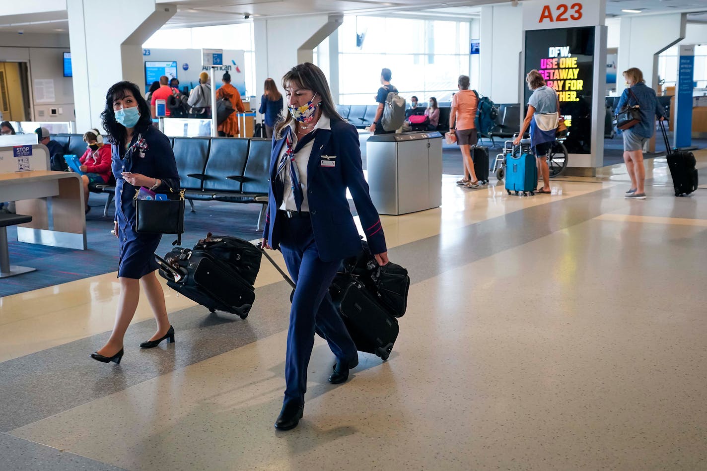 American Airlines flight attendants walk along the concourse at DFW International Airport. (Smiley N. Pool/Dallas Morning News/TNS)