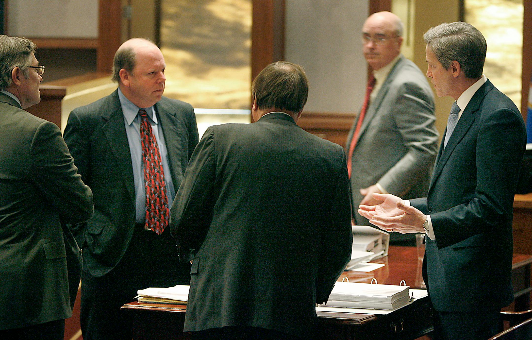 Norm Coleman, right, talked with his legal team and with Ramsey County Election's Director Joe Mansky, left, after Mansky's testimony on the fifth day of Coleman's recount trial in St. Paul.