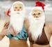 British tourists Louise Norden and Roz Taylor wear Santa masks and hats as they celebrate Christmas at Sydney's Bondi Beach Tuesday, Dec. 25, 2007. (A