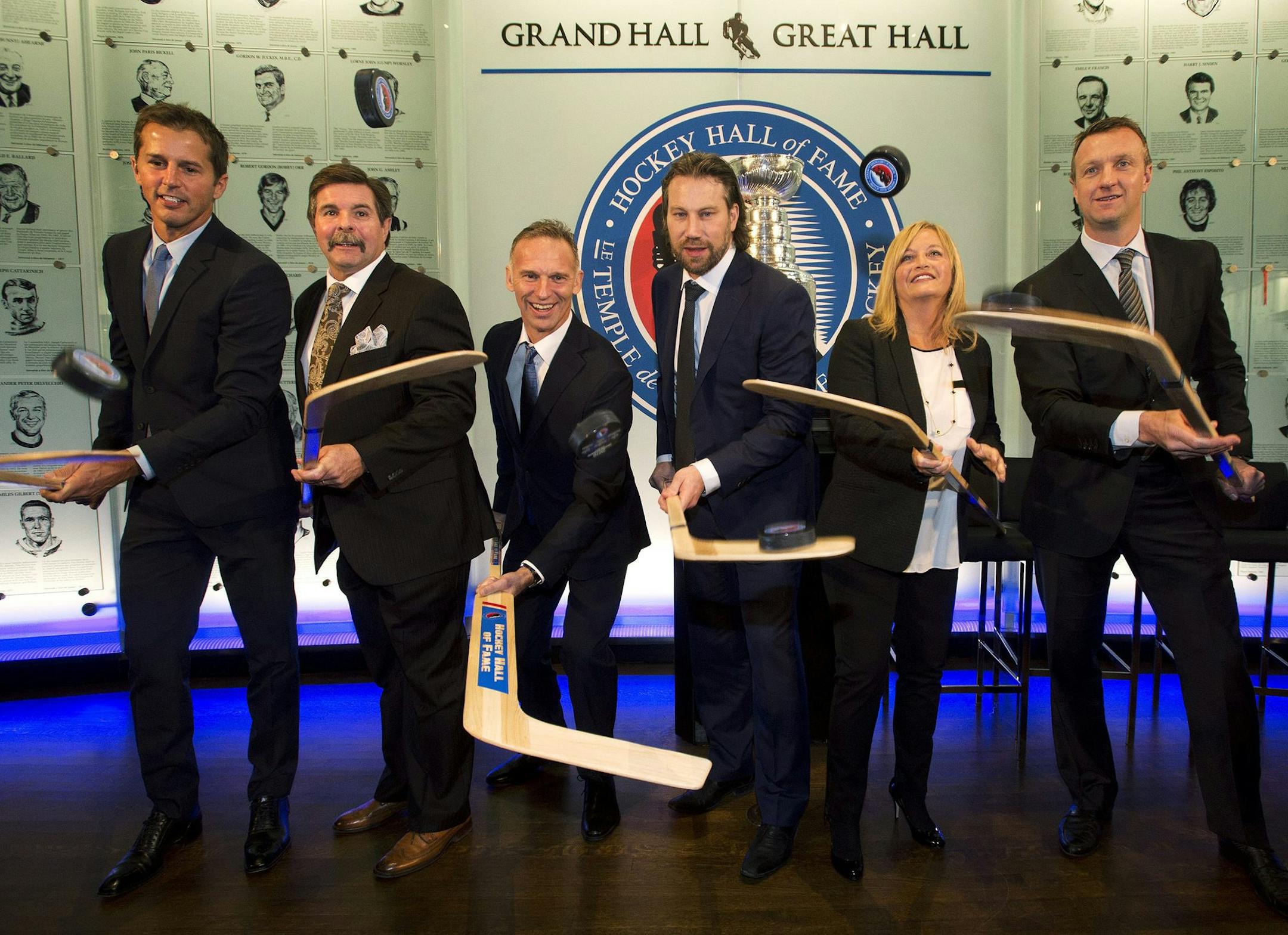 CORRECTS SPELLING OF FIRST NAME TO LINE FROM LYNN - Hockey Hall of Fame 2014 inductees, from left, Mike Modano, Bill McCreary, Dominik Hasek, Peter Forsberg, Line Burns, the wife of the late Pat Burns and Rob Blake pose for a photograph at The Hockey Hall of Fame in Toronto, Friday, Nov. 14, 2014. (AP Photo/The Canadian Press, Nathan Denette)