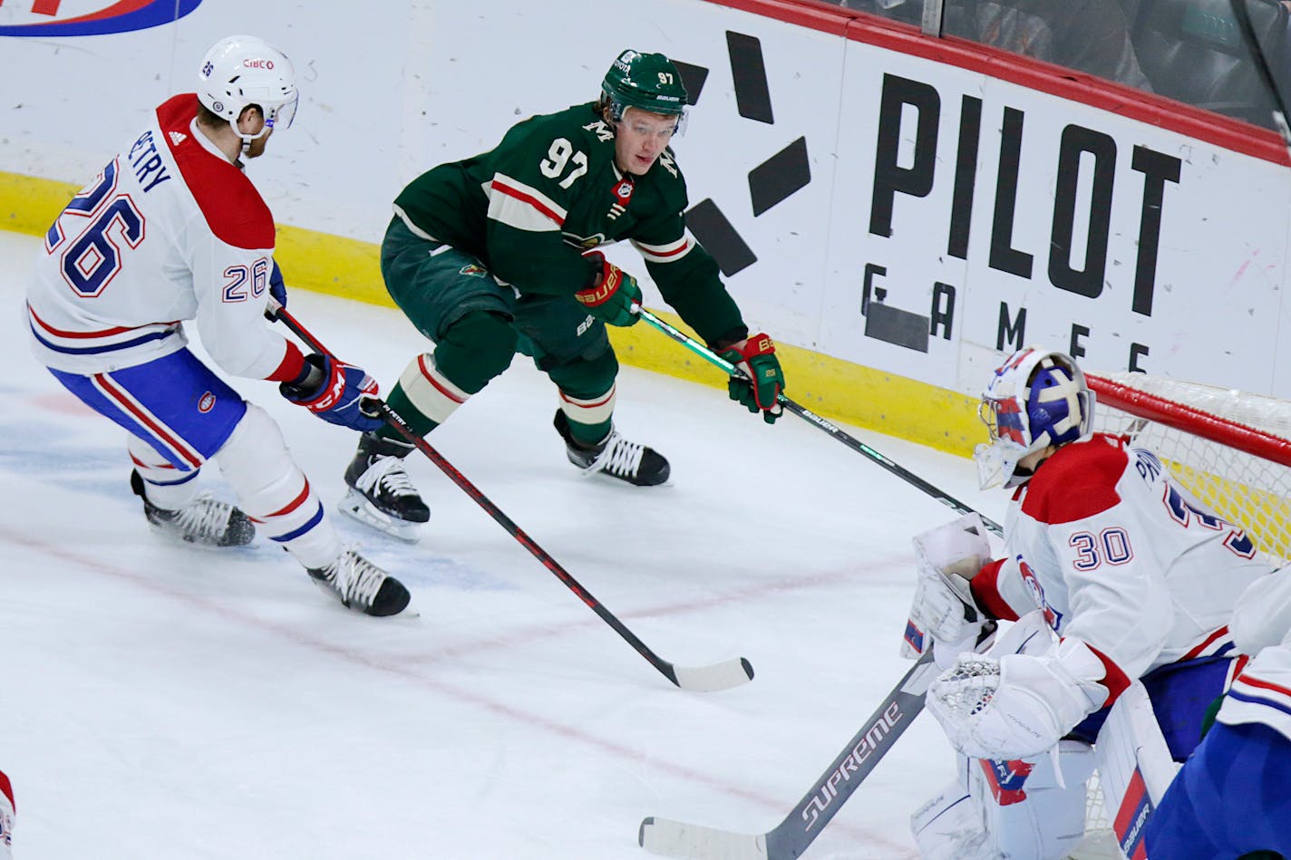 Minnesota Wild left wing Kirill Kaprizov (97) skates past Montreal Canadiens goaltender Cayden Primeau (30) with defense from Montreal Canadiens defenseman Jeff Petry (26) in the first period of an NHL hockey game Monday, Jan. 24, 2022, in St. Paul, Minn. (AP Photo/Andy Clayton-King)