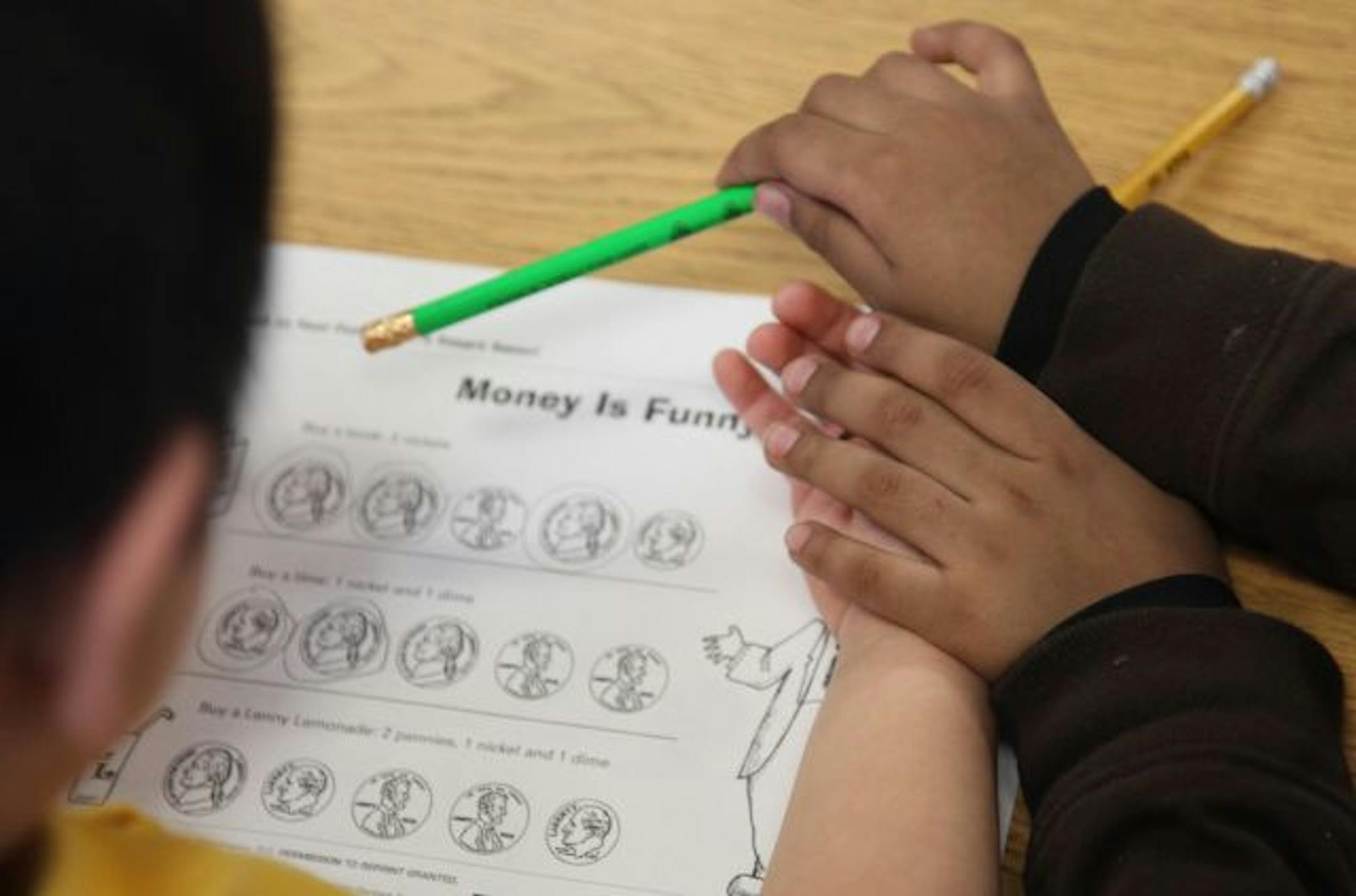 Children from Chelsea Heights Elementary School in St. Paul did a work sheet Wednesday as learned about saving money in the bank.