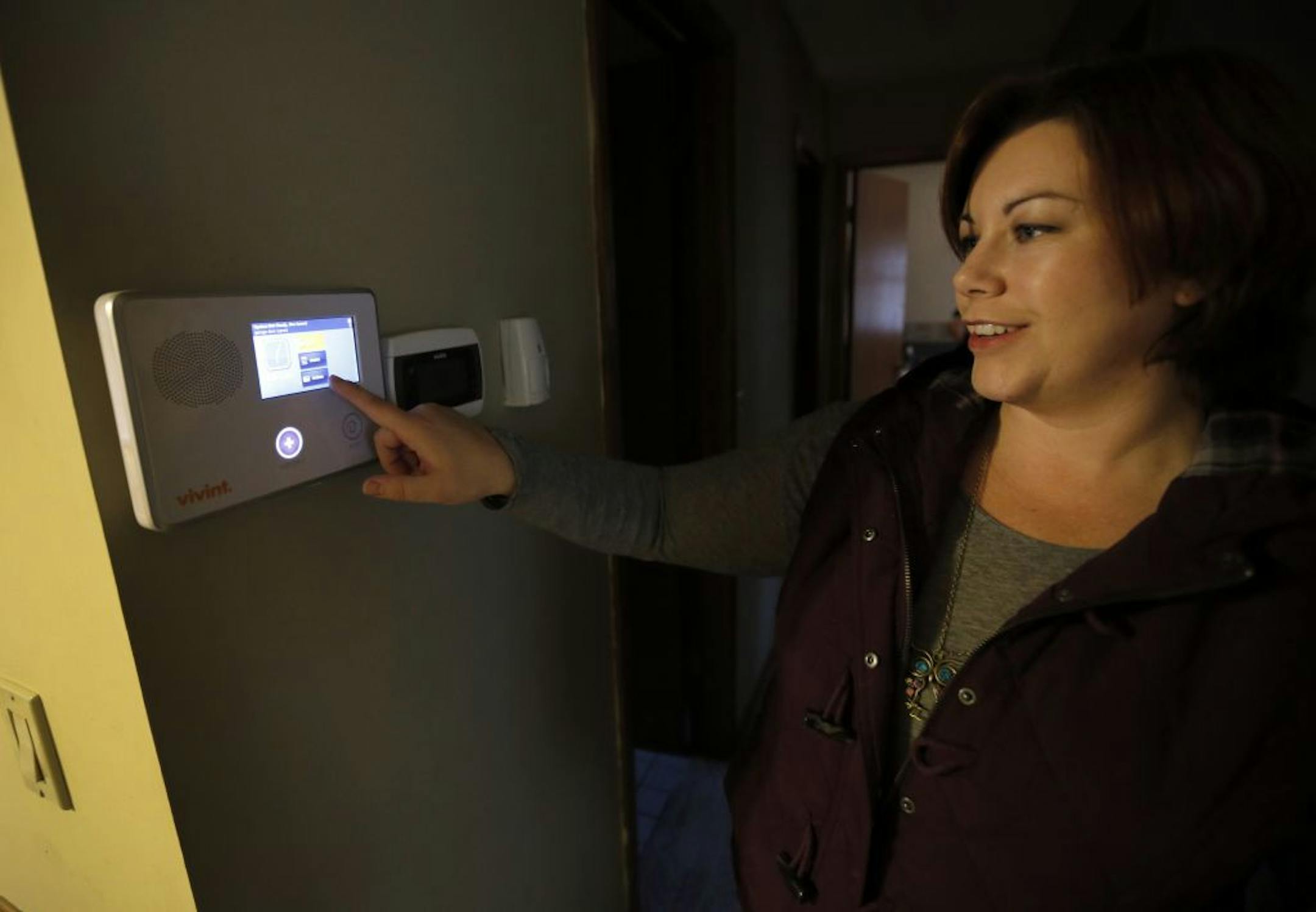 Lindsey Peterson-Smiley demonstrated on the touchpad control of her home security system at her Brooklyn Center home.