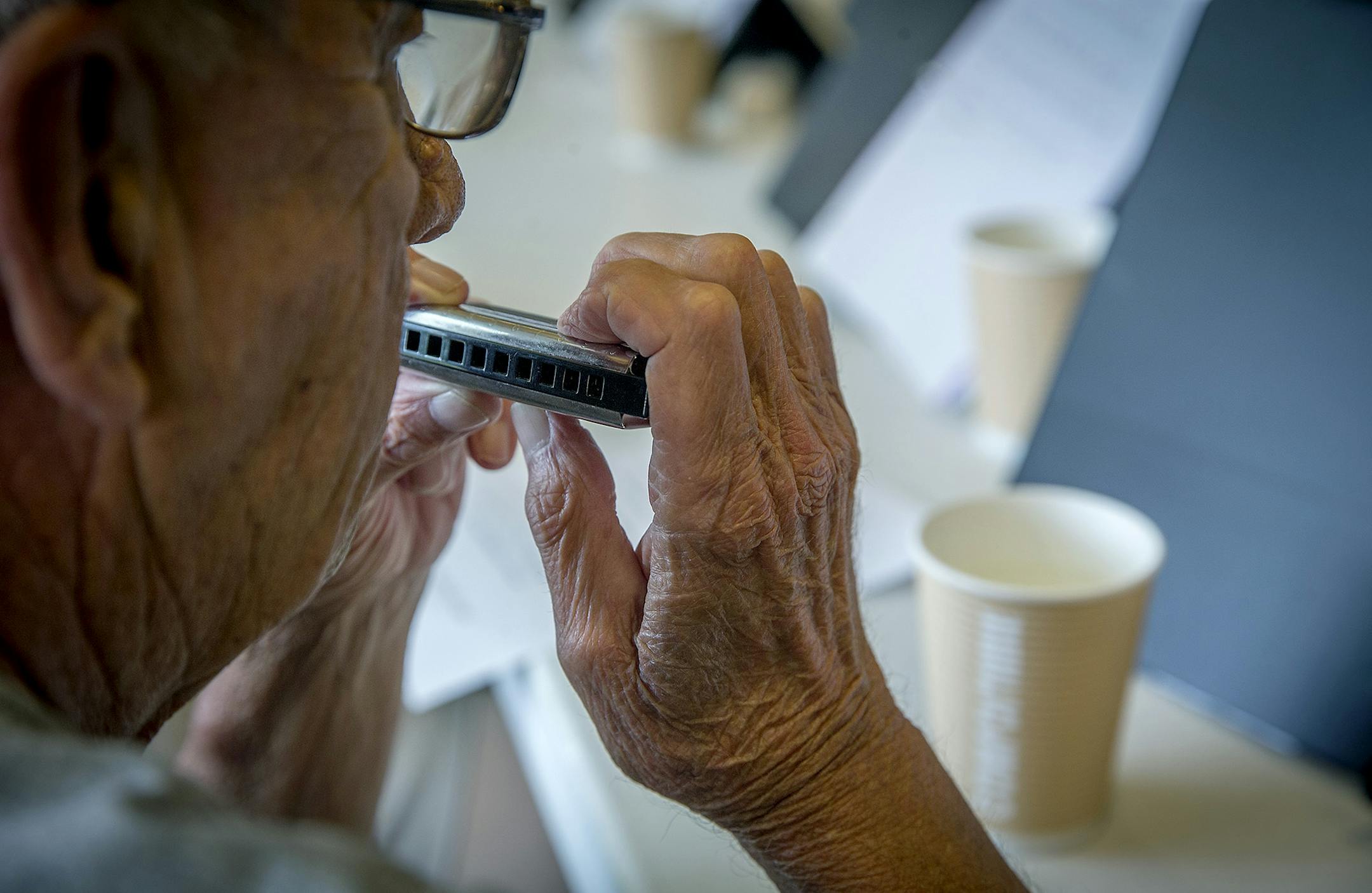Leland Flanders waited for his cue to play the harmonica during a concert at Methodist Hospital, Thursday, June 28, 2018 in St. Louis Park, MN. Leland and other patients with COPD or other breathing-related disorders have been prescribed harmonicas, which they use for fun, but also to augment their usual pulmonary rehab drills and exercises. ] ELIZABETH FLORES ï liz.flores@startribune.com