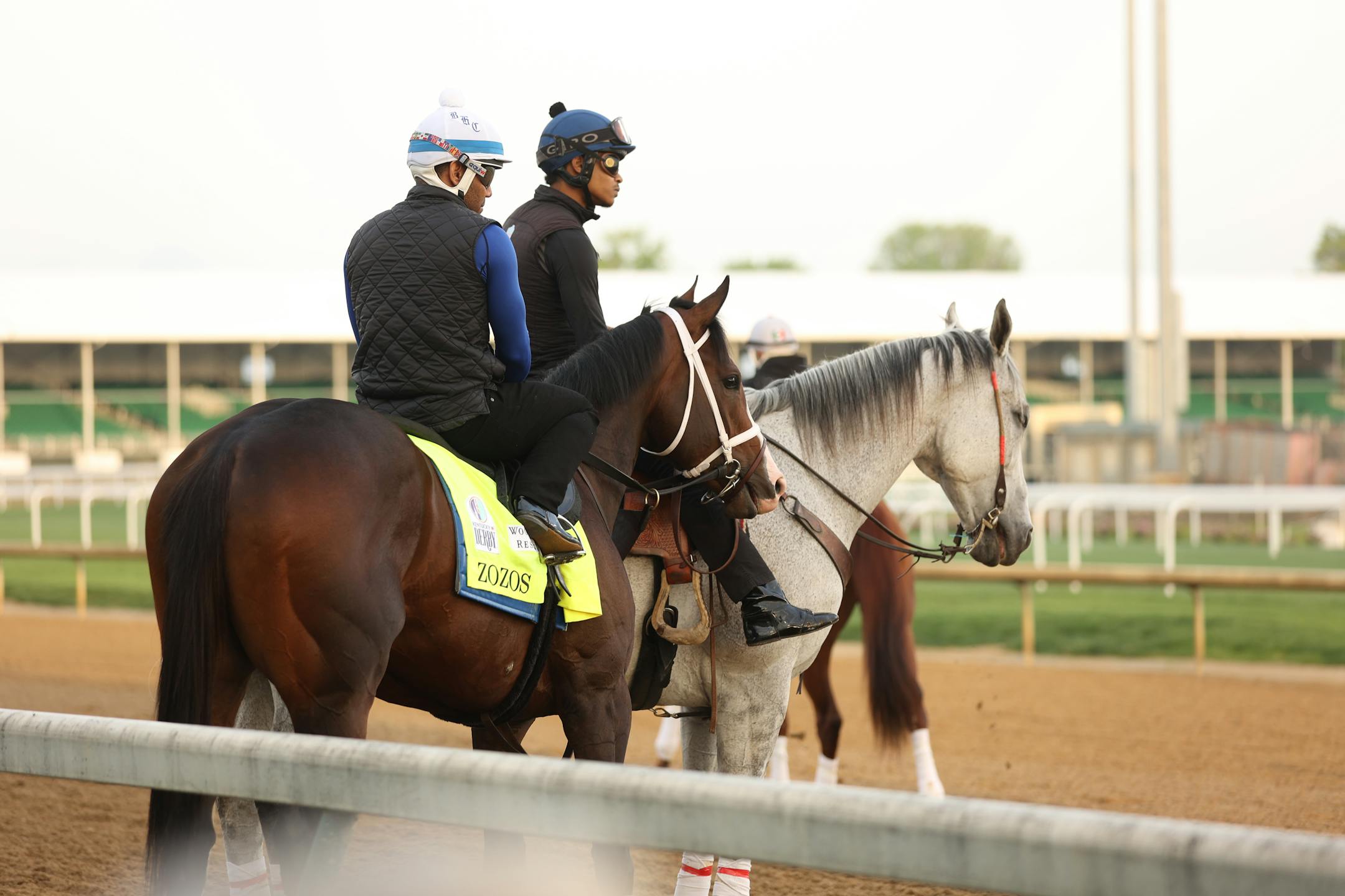 Zozos watching action on the track at Churchill Downs.