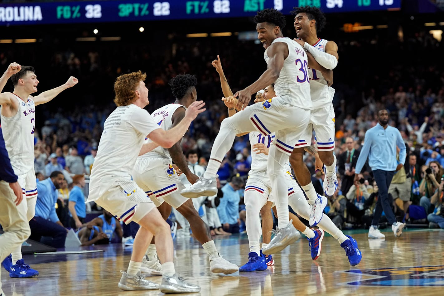 Kansas guard Ochai Agbaji celebrates with teammates after their win against North Carolina in a college basketball game in the finals of the Men's Final Four NCAA tournament, Monday, April 4, 2022, in New Orleans. (AP Photo/David J. Phillip)