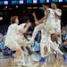 Kansas guard Ochai Agbaji celebrates with teammates after their win against North Carolina in a college basketball game in the finals of the Men's Fin