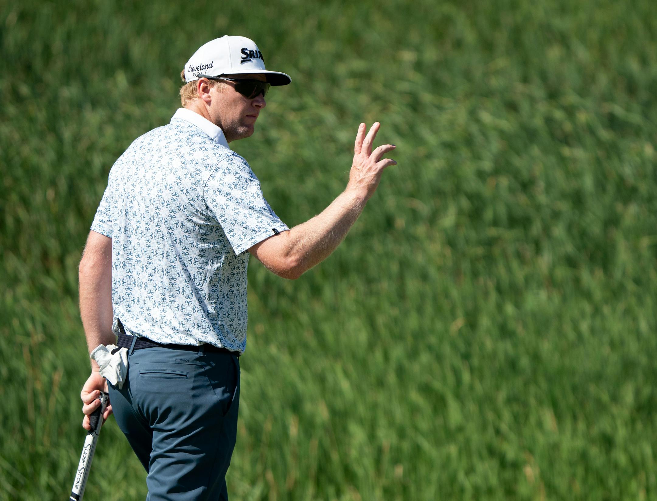 Ryan Brehm waves to the crowd after a successful shot on the 10th hole.