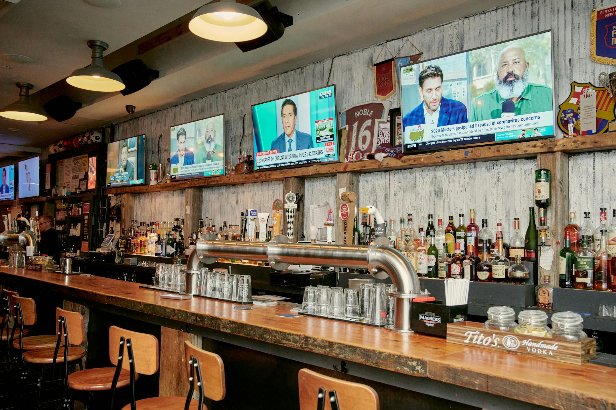Sports bars around the country, like this one in Manhattan, sit empty during what is usually the beginning of a busy period.