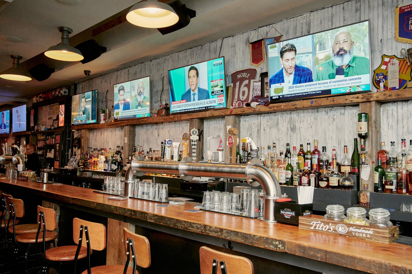 Sports bars around the country, like this one in Manhattan, sit empty during what is usually the beginning of a busy period.