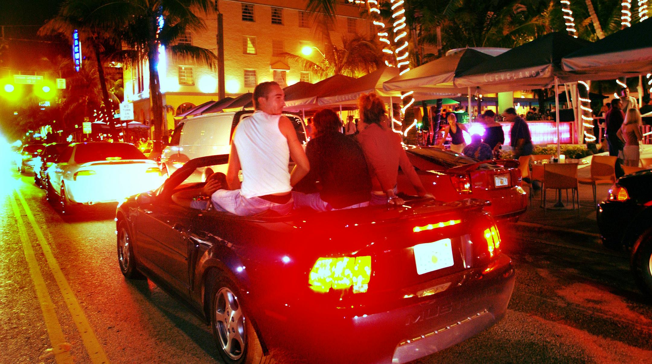 Miami Beach is getting the word out to universities that it will increase its enforcement of laws to address crime and quality of life issues for next year's Spring Break. File photo of cars cruising down Ocean Drive during spring break. (Roberto Gonzalez/The Orlando Sentinel/TNS)