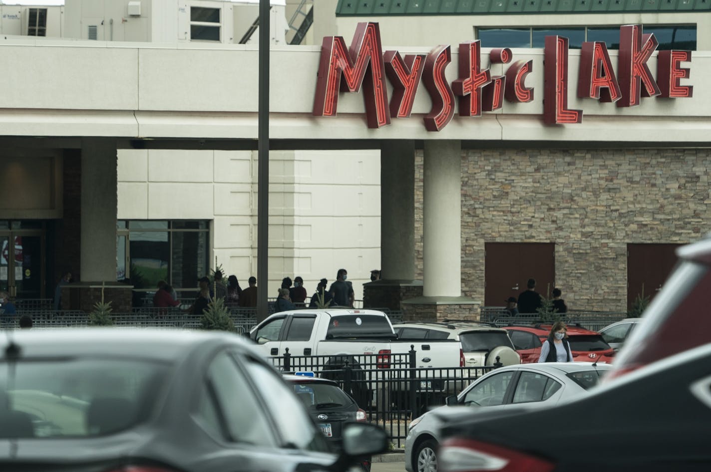 People lined up to get into the Mystic Lake Casino in Shakopee, Minn., on Tuesday, May 26, 2020 on the first day it reopened after COVID-19 shut it down two months ago.