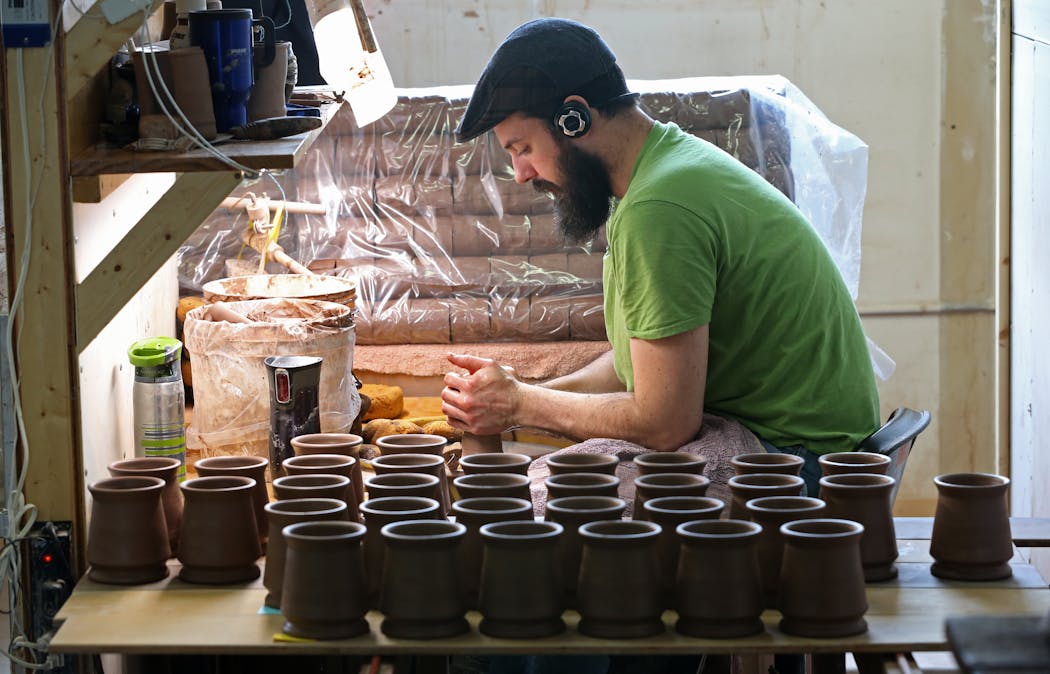 Deneen Pottery employee Jonathan Conrad hand formed mugs on a pottery wheel on 4/30/14. Bruce Bisping/Star Tribune bbisping@stribune