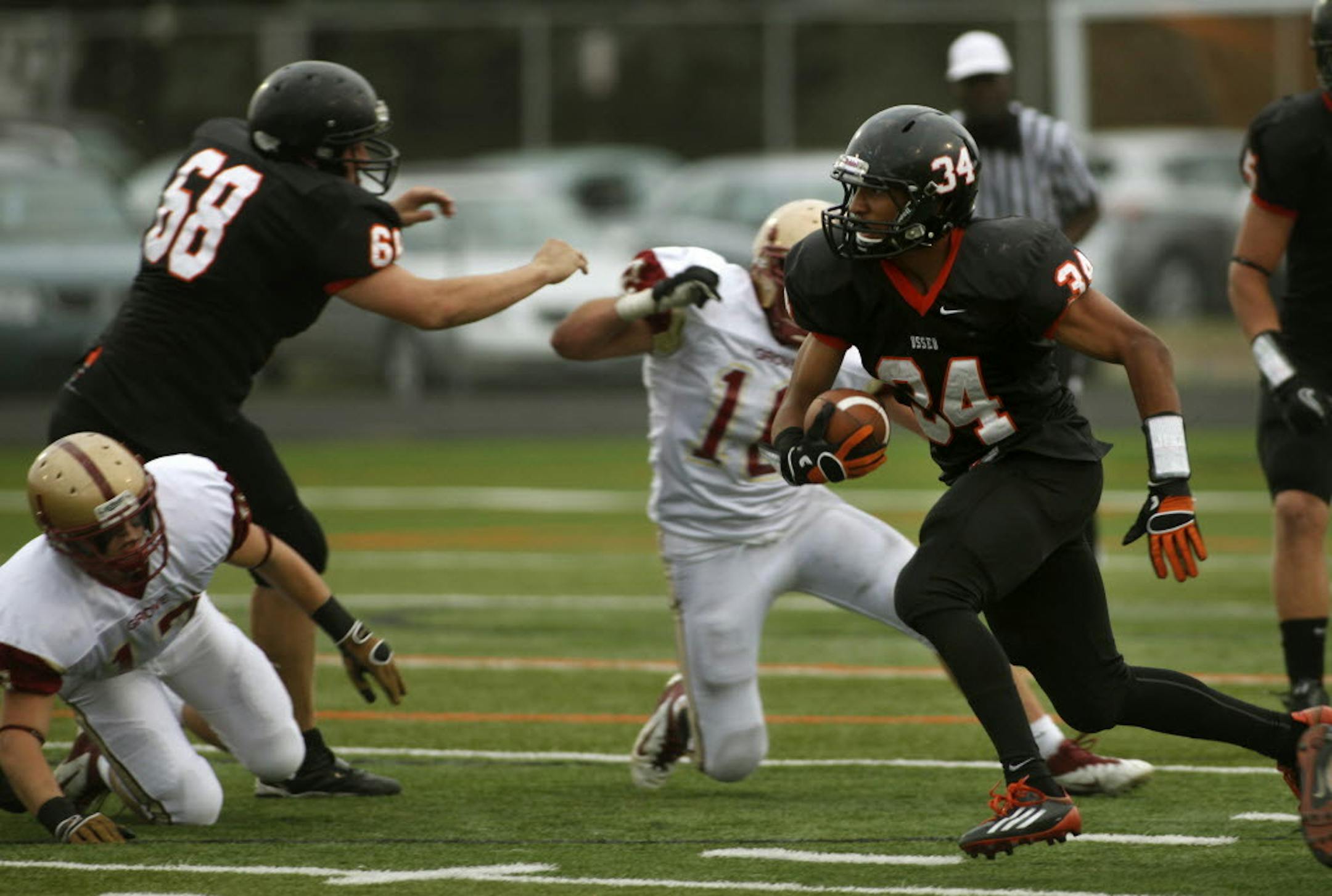 Orioles running back Bridge Tusler, shown in this game in 2011, accounted for four touchdowns against Blaine on Friday. He threw a scoring pass, caught a scoring pass, rushed for a touchdown and intercepted a pass and ran it in. Star Tribune file photo
