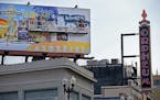 A billboard on Hennepin Avenue gets worked on in downtown Minneapolis in 2014. Minneapolis is considering expanding the area where off-premise adverti
