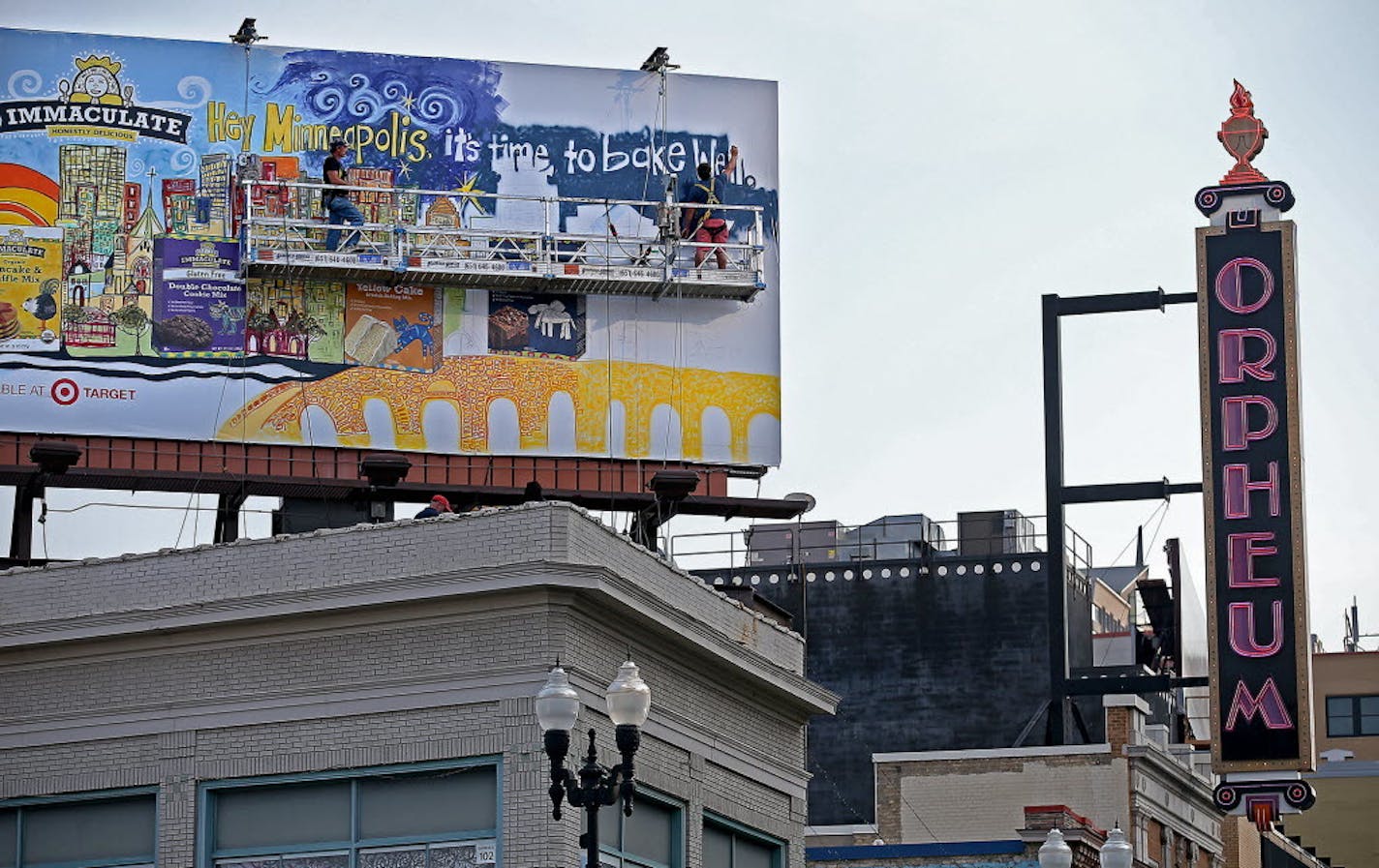 A billboard on Hennepin Avenue gets worked on in downtown Minneapolis in 2014. Minneapolis is considering expanding the area where off-premise advertising signs could be erected.