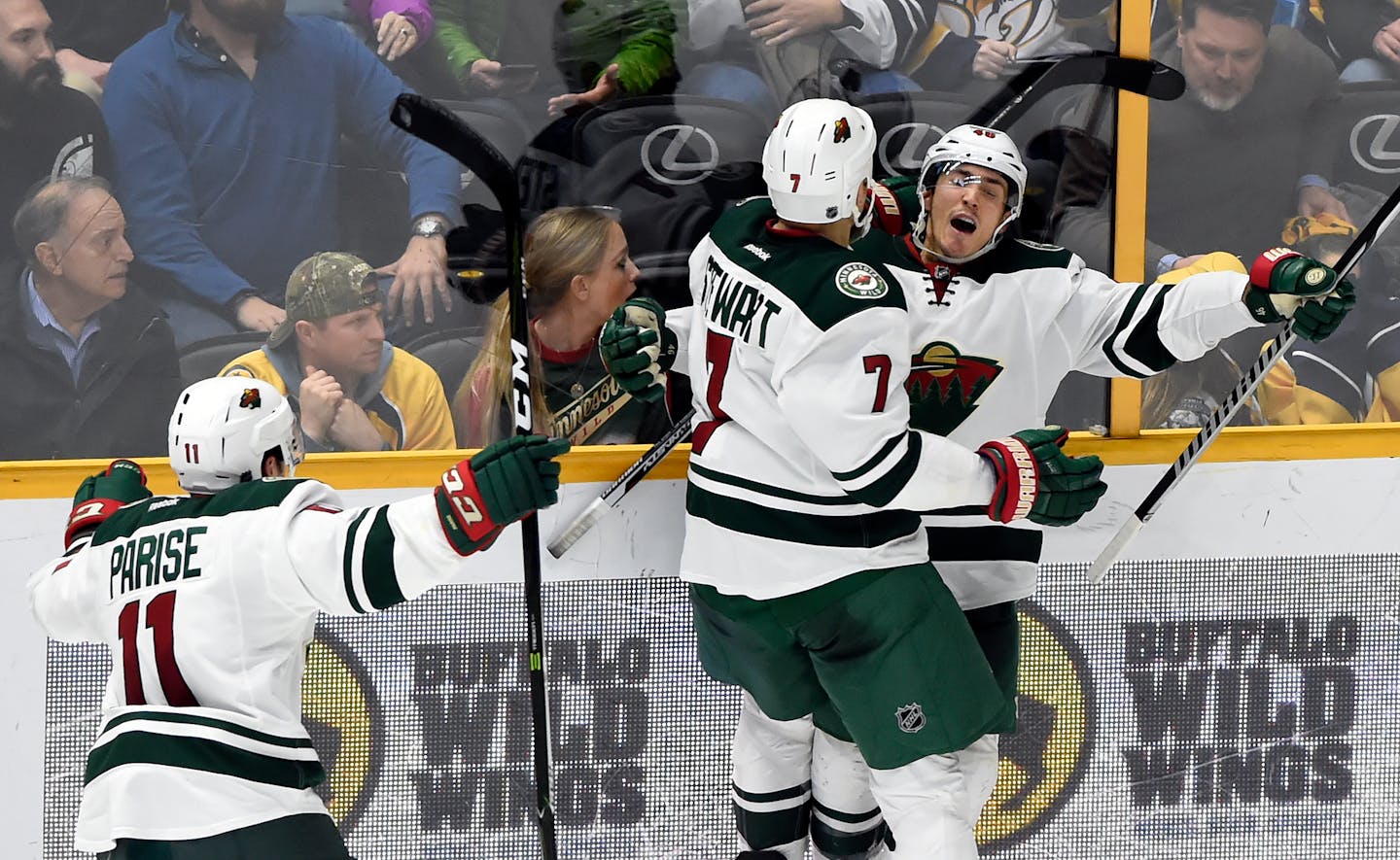 Wild defenseman Jared Spurgeon, right, celebrated with right wing Chris Stewart (7) and left wing Zach Parise (11) after Spurgeon scored the winning goal against the Nashville Predators in overtime Tuesday.