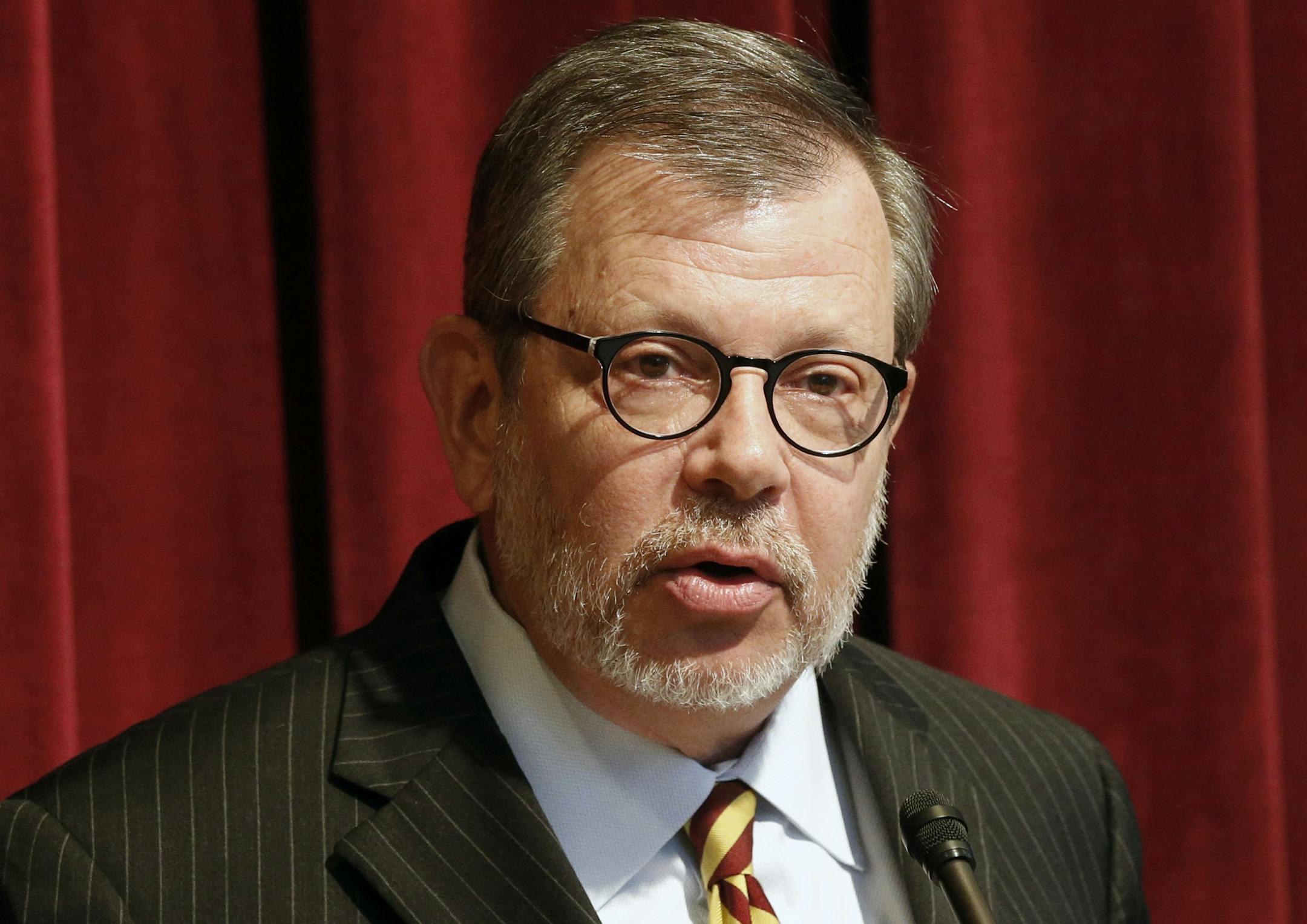FILE - In this Aug. 7, 2015, file photo, University of Minnesota President Eric Kaler speaks in Minneapolis. A university investigation called for punishing 10 players following an alleged sexual assault on campus last fall. Coach Tracy Claeys was fired in part because of his public support of his players differed with Kaler and athletic director Mark Coyle. (AP Photo/Jim Mone, File)