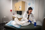 Nurse practitioner Shira Klane cleans a room after seeing a patient during her shift as a clinician at the Planned Parenthood Mankato Health Center on