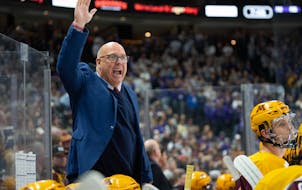 Minnesota head coach Robert Motzko argues with an official in the first period of his team’s game against St. Thomas Friday, Oct. 13, 2023, at Xcel 
