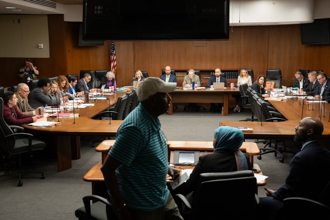 Mohamed Egal, front left, head of the Mulda Members Association, speaks at a committee hearing on the Uber and Lyft bill Tuesday in St. Paul.