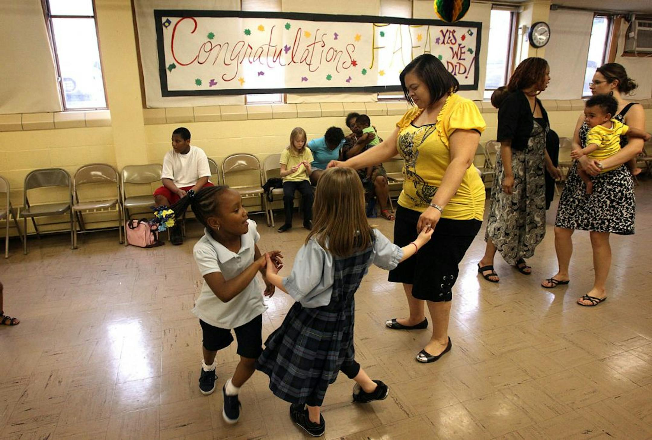 Educational assistant Keturah White (cq). White, who has been at the school for six years, danced with some of the children before the start of the pep rally. White said she was relieved when she heard that the school would remain open, "…because I can touch the lives of more children."