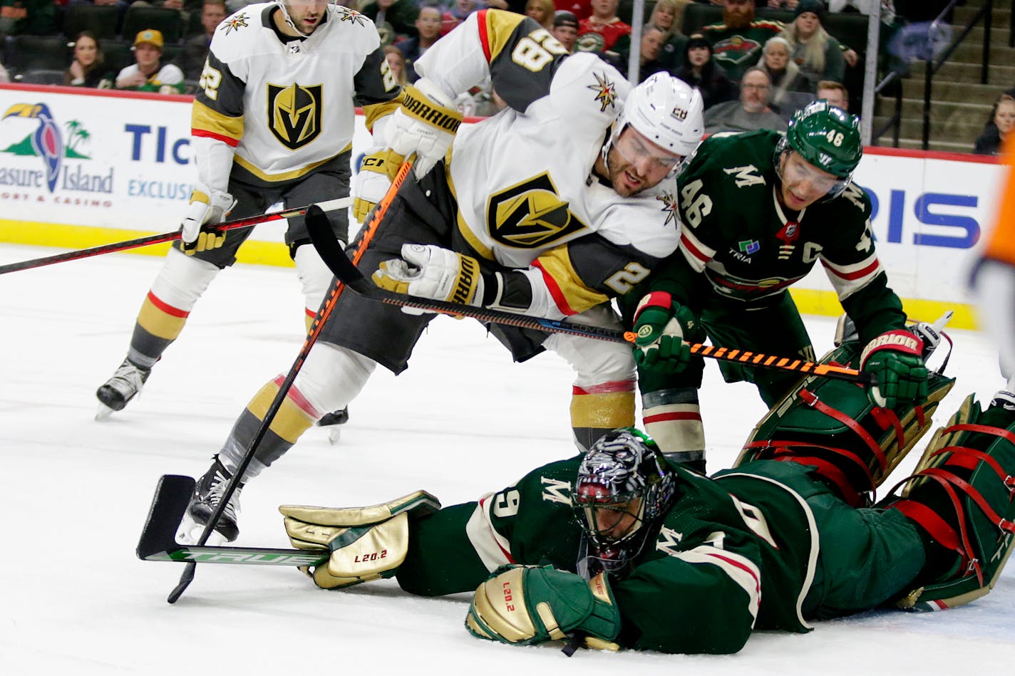 Minnesota Wild goaltender Marc-Andre Fleury (29) dives on the puck with Vegas Golden Knights left wing William Carrier (28) and Minnesota Wild defenseman Jared Spurgeon (46) look on in the second period of an NHL hockey game Thursday, Feb. 9, 2023, in St. Paul, Minn. (AP Photo/Andy Clayton-King)