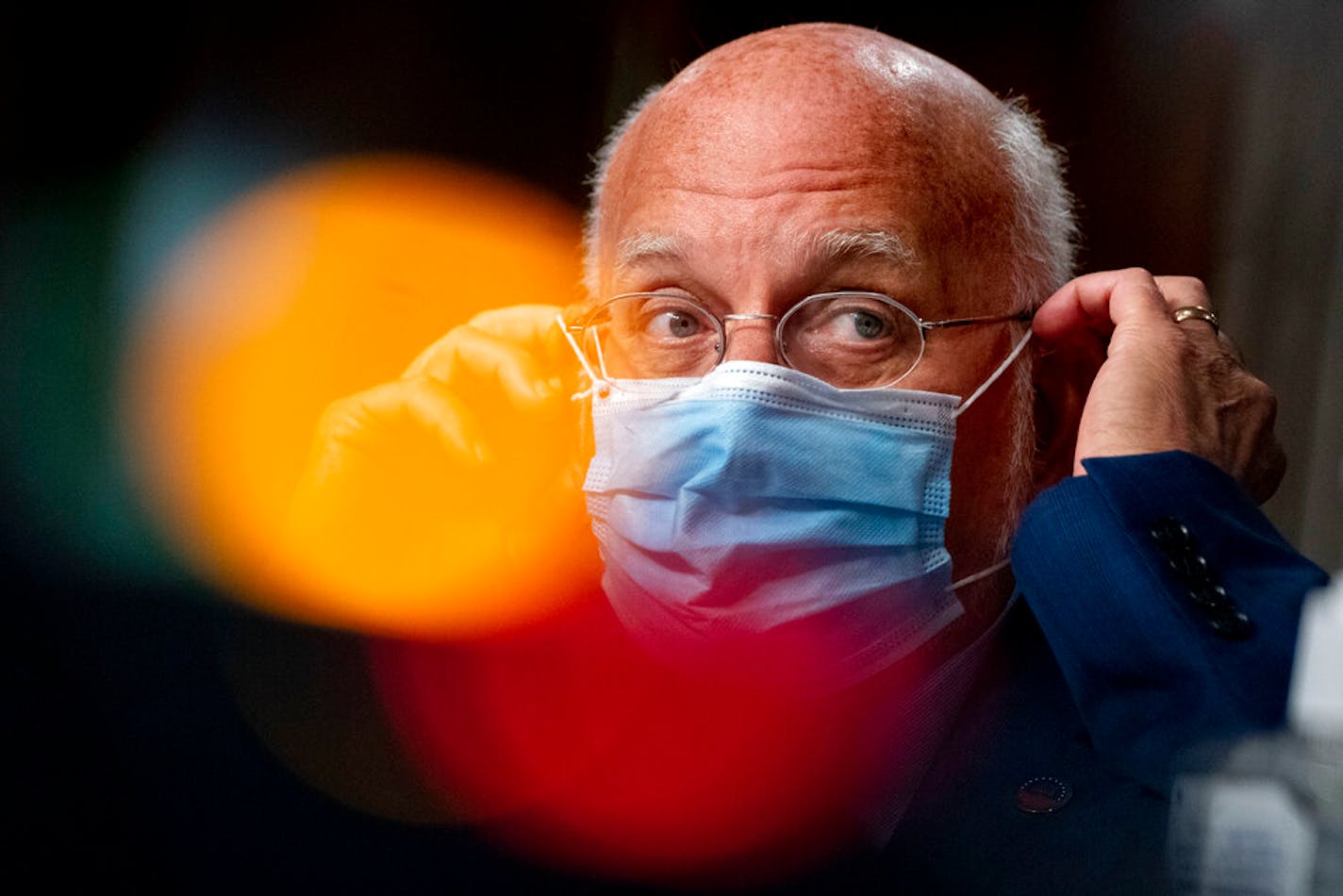 Centers for Disease Control and Prevention Director Dr. Robert Redfield puts his mask back on after speaking at a Senate Appropriations subcommittee hearing in September.