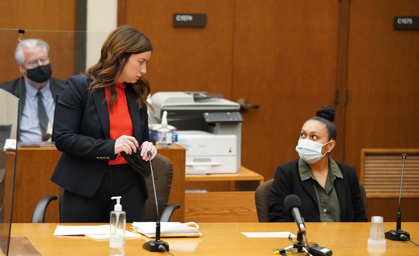 Defense attorney Amanda Montgomery, left, conferred with Elsa Segura before answering "no" when Judge Peter Cahill asked if she wanted to make a statement before her sentencing. Former Hennepin County probation officer, Elsa Segura, is sentenced, Tuesday, Nov. 9, 2021, in Hennepin County Court, Minneapolis, Minn., for luring Realtor, Monique Baugh, to a fake home showing where she was kidnapped and murdered.