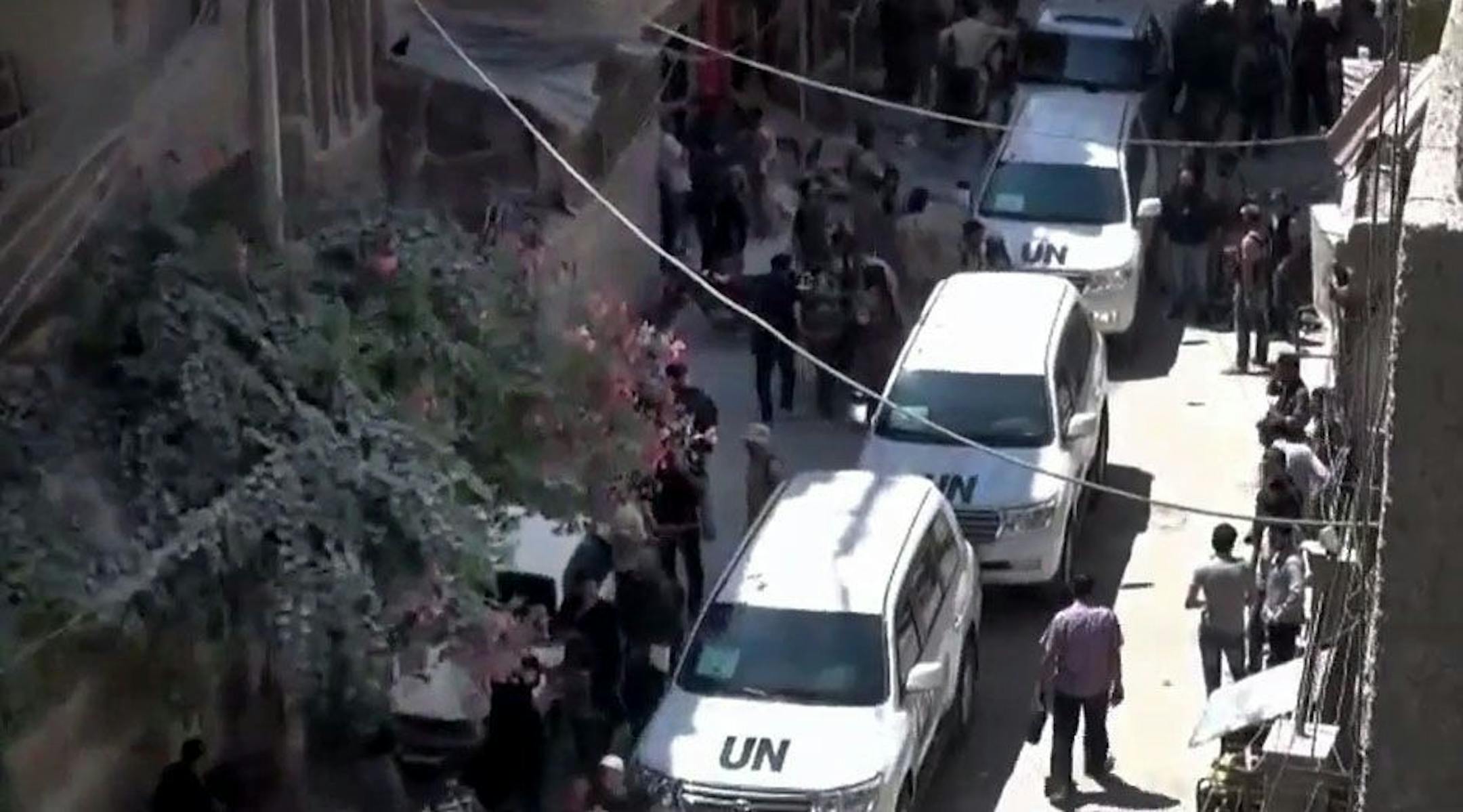 In this image taken from video obtained from the Shaam News Network, which has been authenticated based on its contents and other AP reporting, Syrians welcome the UN investigation team in Damascus countryside, Syria, on Wednesday, Aug. 28, 2013.