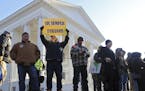 Gun-rights supporters gather on Bank near the state Capitol in Richmond, Va., Monday morning Jan. 20, 2020. Gun-rights activists and other groups are 