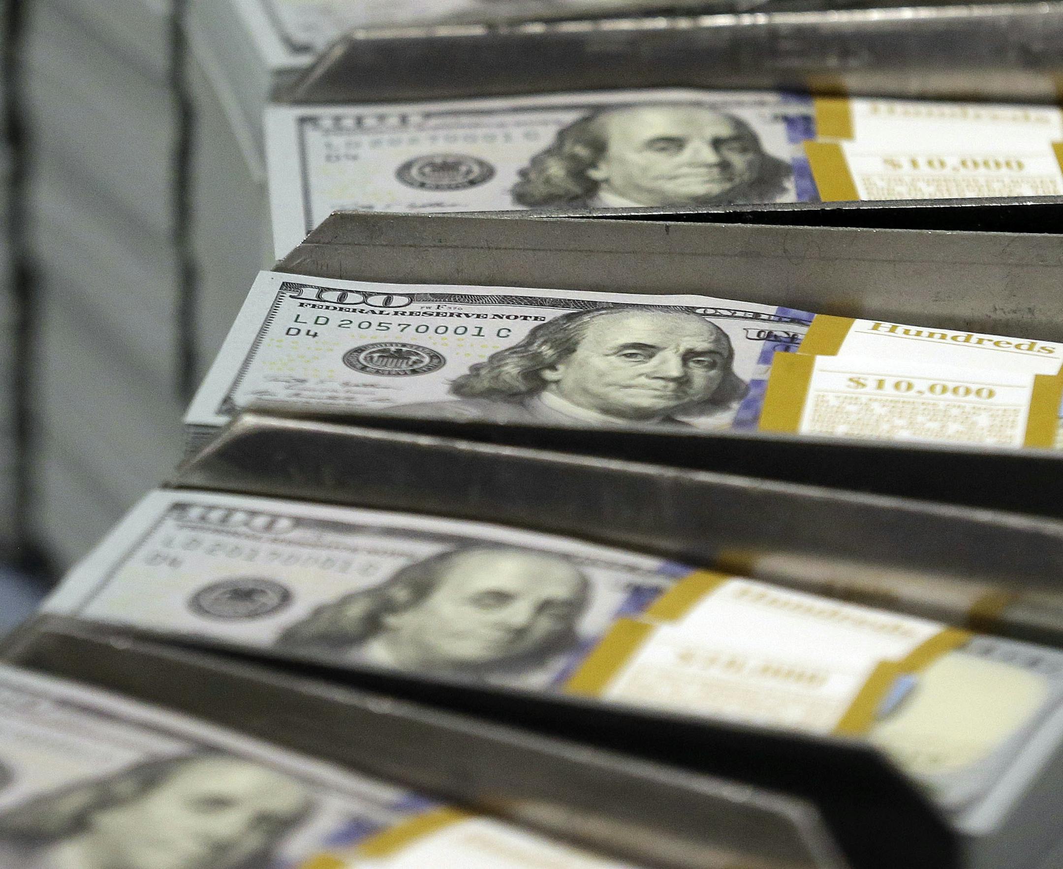 FILE - In this Sept. 24, 2013, file photo, freshly-cut stacks of $100 bills make their way down the line at the Bureau of Engraving and Printing Western Currency Facility in Fort Worth, Texas. Borrowing money from family can create an awkward situation. Setting up a loan agreement can make it easier to avoid hurt feelings and disputes down the road. (AP Photo/LM Otero, File)