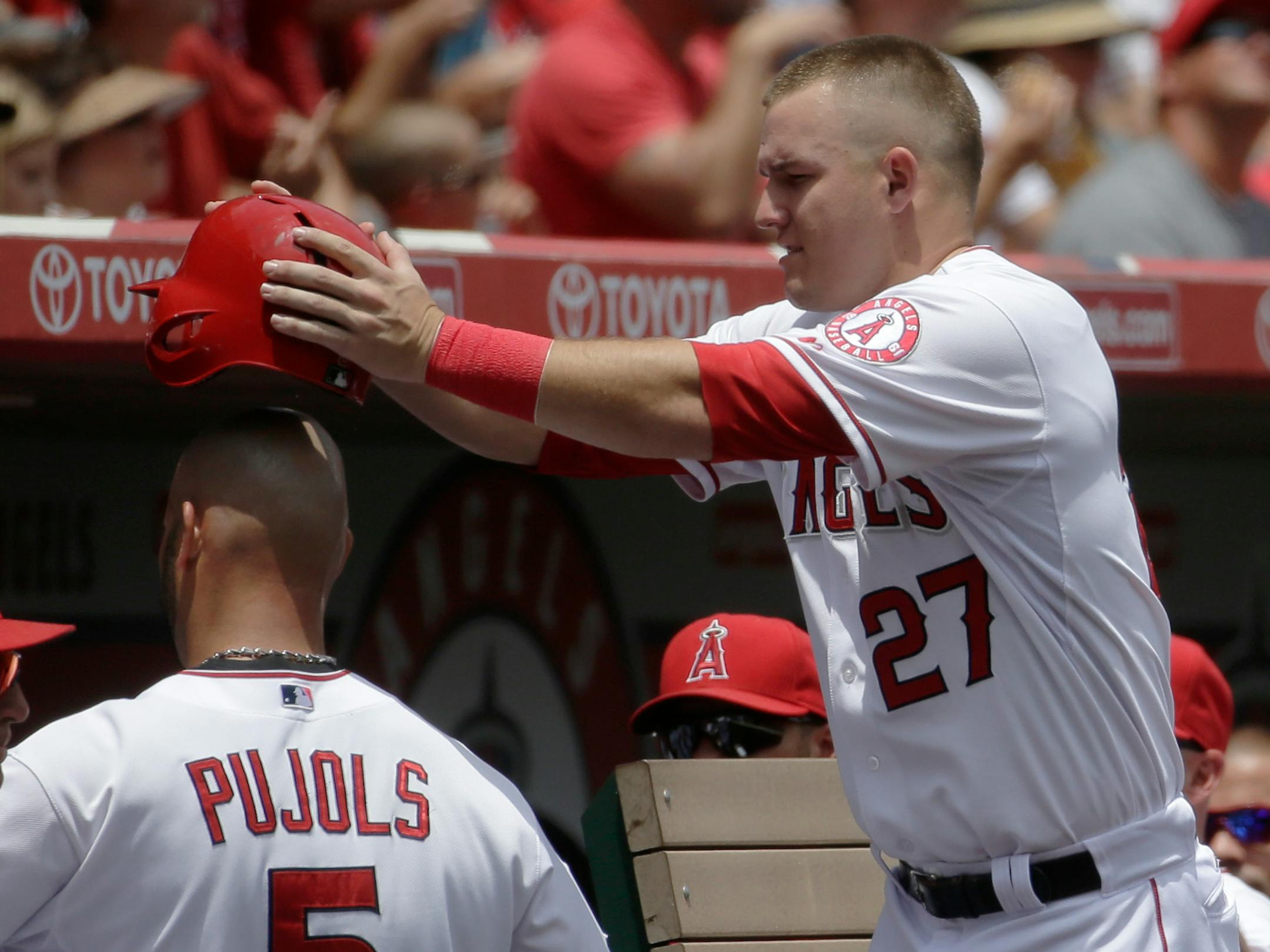 The Angels' Albert Pujols, left, celebrated with Mike Trout after scoring on a hit by Erick Aybar against the Twins during the first inning Thursday.