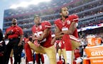 On Sept. 12, San Francisco 49ers safety Eric Reid and quarterback Colin Kaepernick kneel during the national anthem before an NFL football game agains