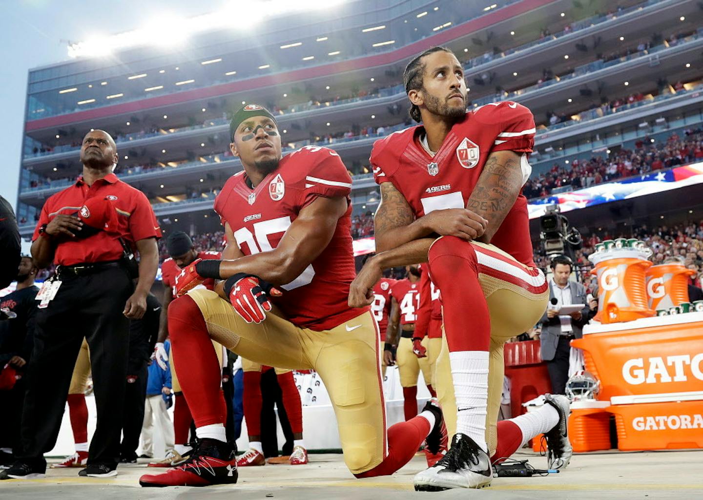 On Sept. 12, San Francisco 49ers safety Eric Reid and quarterback Colin Kaepernick kneel during the national anthem before an NFL football game against the Los Angeles Rams in Santa Clara, Calif. Since Kaepernick began his protest during the pre-season, other pro and high school athletes have joined in him.