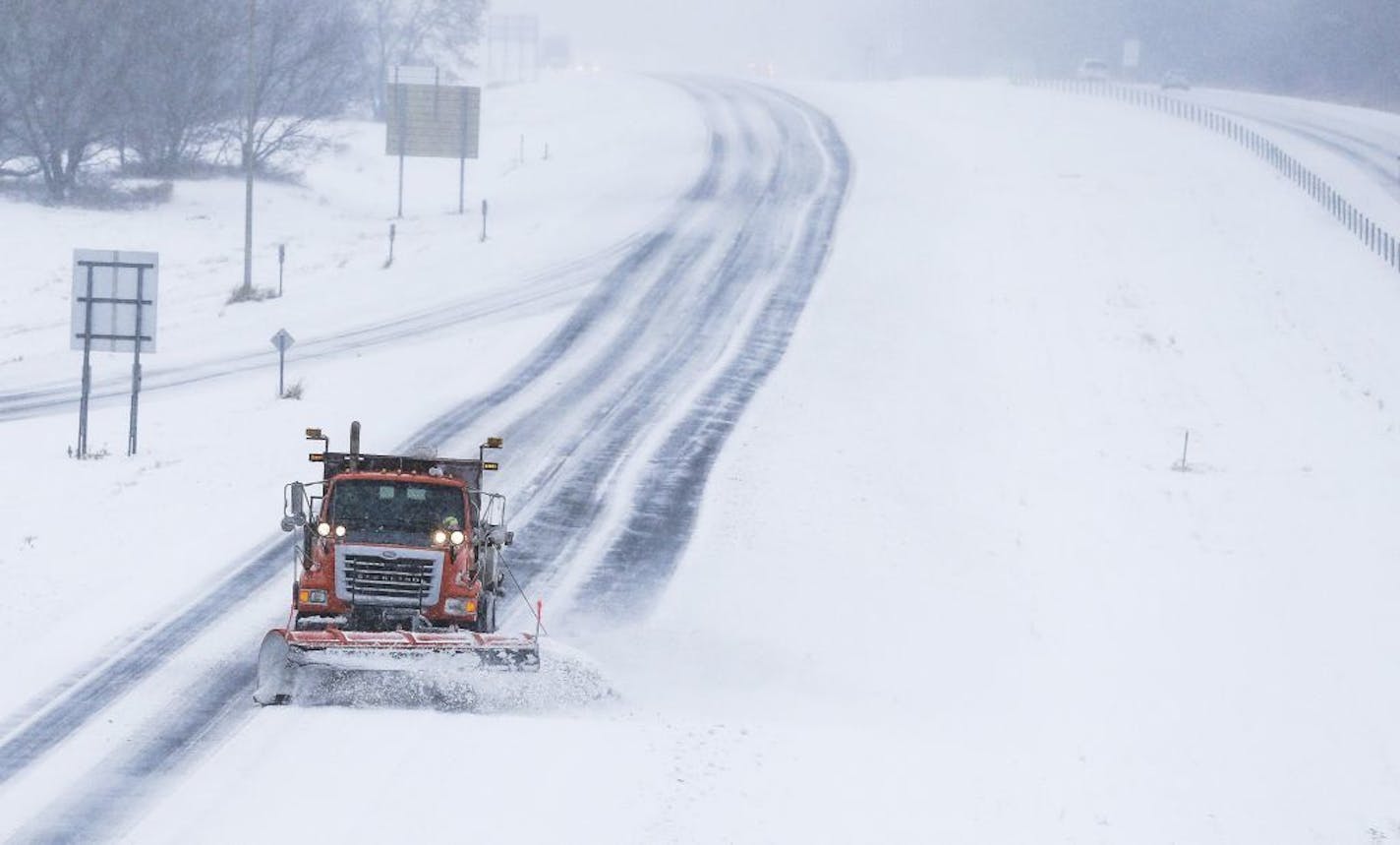 A MnDOT snow plow clears snow on northbound Hwy. 52 at the Marion Road Southeast exit Saturday, Dec. 1, 2018, south of Rochester, Minn.