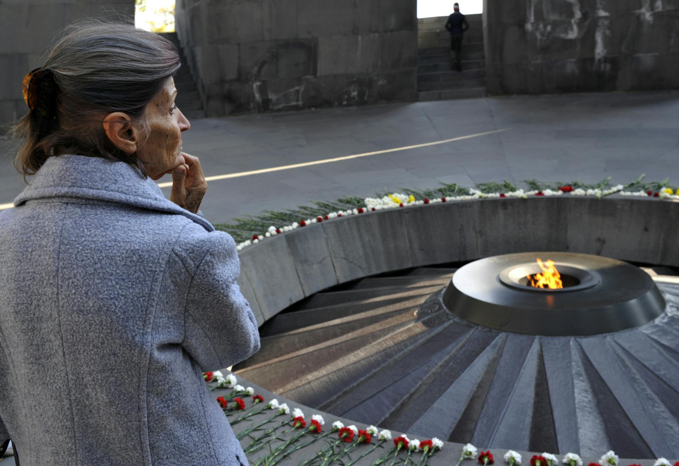 A woman stands at the Tzitzernakaberd memorial to the victims of mass killings by Ottoman Turks, in the Armenian capital Yerevan, Armenia, Wednesday, Oct. 30, 2019. The U.S. House of representatives has voted overwhelmingly to recognize the century-old mass killings of Armenians by Ottoman Turks as genocide. The move is a clear rebuke to NATO ally Turkey in the wake of its invasion of northern Syria. (AP Photo/Hakob Berberyan)