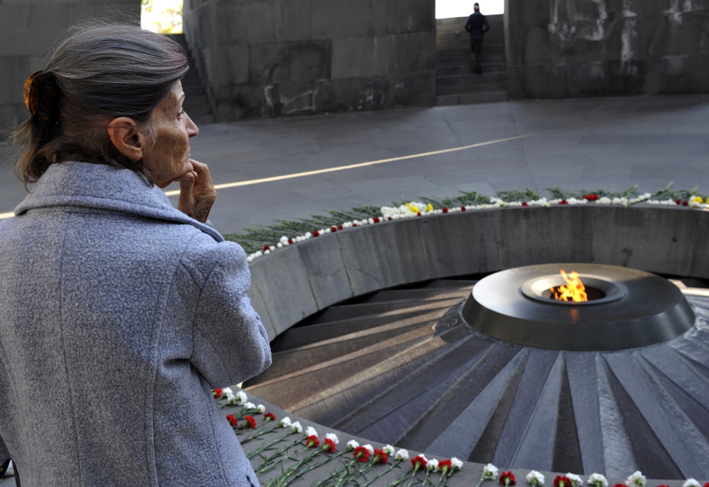 A woman stands at the Tzitzernakaberd memorial to the victims of mass killings by Ottoman Turks, in the Armenian capital Yerevan, Armenia, Wednesday, Oct. 30, 2019. The U.S. House of representatives has voted overwhelmingly to recognize the century-old mass killings of Armenians by Ottoman Turks as genocide. The move is a clear rebuke to NATO ally Turkey in the wake of its invasion of northern Syria. (AP Photo/Hakob Berberyan)