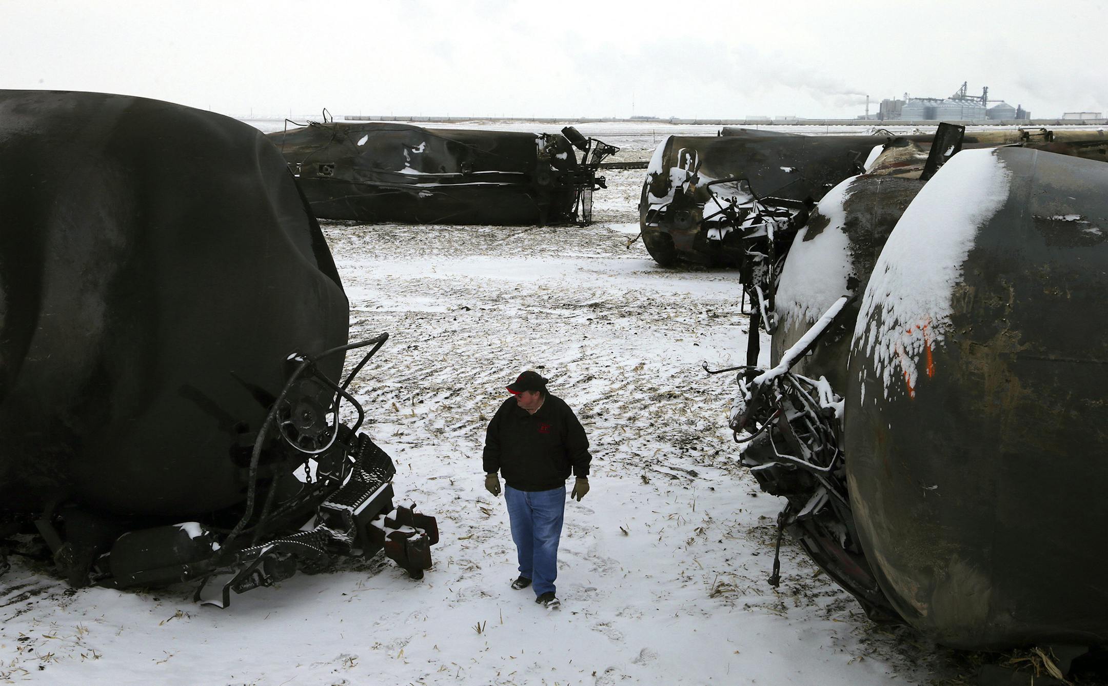Ed McConnell, the mayor of Casselton, N.D., among wreckage from a recent oil-train explosion in Casselton, N.D., Jan. 16, 2014. A fiery rail accident last month in Casselton, N.D., which prompted residents to evacuate the town, has shattered people's confidence in the crude-oil convoys that rumble past seven times a day. (Jim Wilson/The New York Times) ORG XMIT: MIN2014021912571962