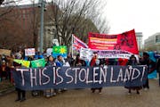 A Dakota Access Pipeline protest in Washington, D.C. People are holding a banner that reads "This is stolen land."