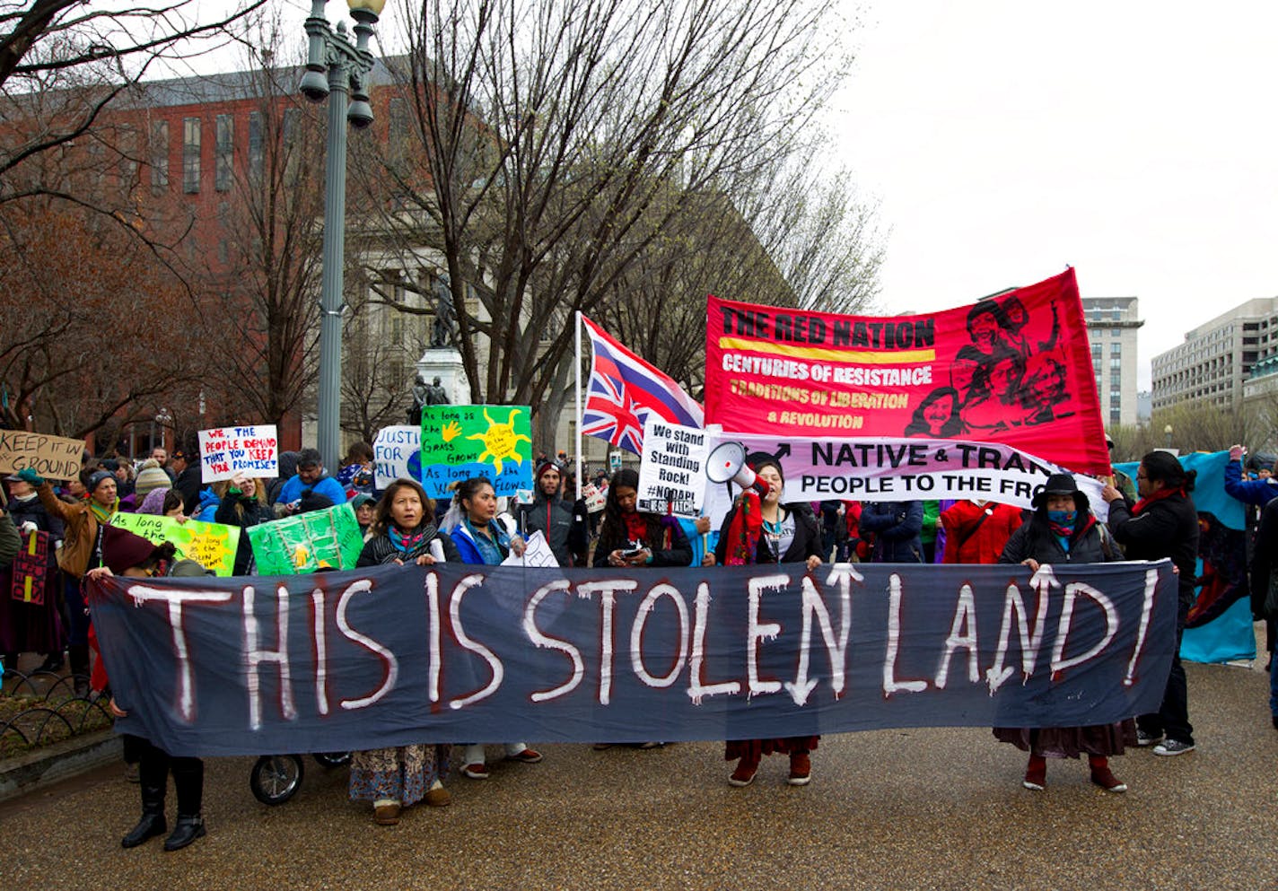 A Dakota Access Pipeline protest in Washington, D.C. People are holding a banner that reads "This is stolen land."