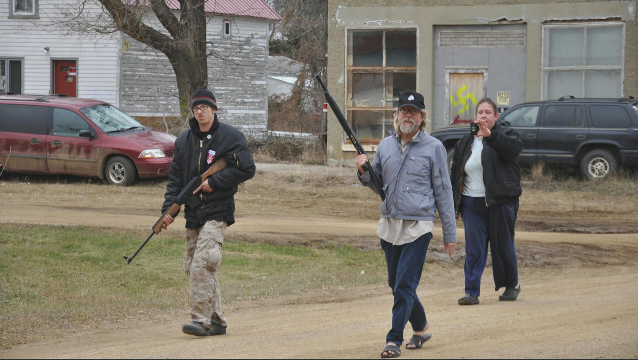Kynan Dutton, Craig Cobb and Deb Henderson patrol their neighborhood in Leith, N.D., in the film "Welcome to Leith."