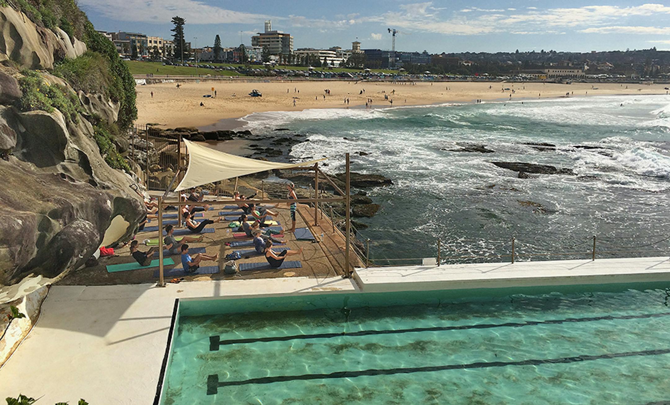 A pool and beach-side yoga class in boat pose near the deck of the smaller of two outdoor pools at Bondi Icebergs Club on the south end of the beach. ] Travel story on coastal beaches in Australia Star Tribune photos by Rochelle Olson
