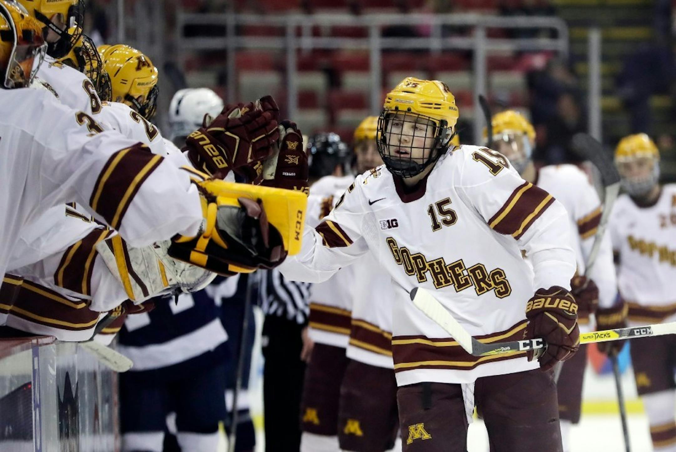 Minnesota forward Rem Pitlick is greeted by teammates after scoring during the first period of an NCAA college hockey semifinal match against Penn State in the Big Ten Tournament, Friday, March 17, 2017, in Detroit.