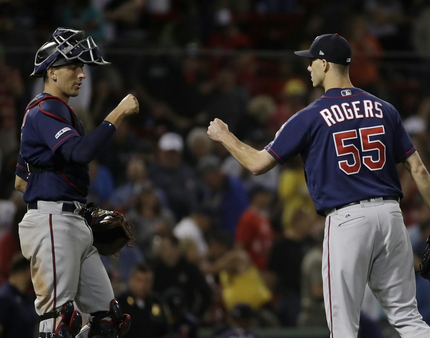 Minnesota Twins closer Taylor Rogers and catcher Jason Castro celebrate their 6-5 victory over the Boston Red Sox in a baseball game at Fenway Park, Tuesday, Sept. 3, 2019, in Boston. (AP Photo/Elise Amendola)