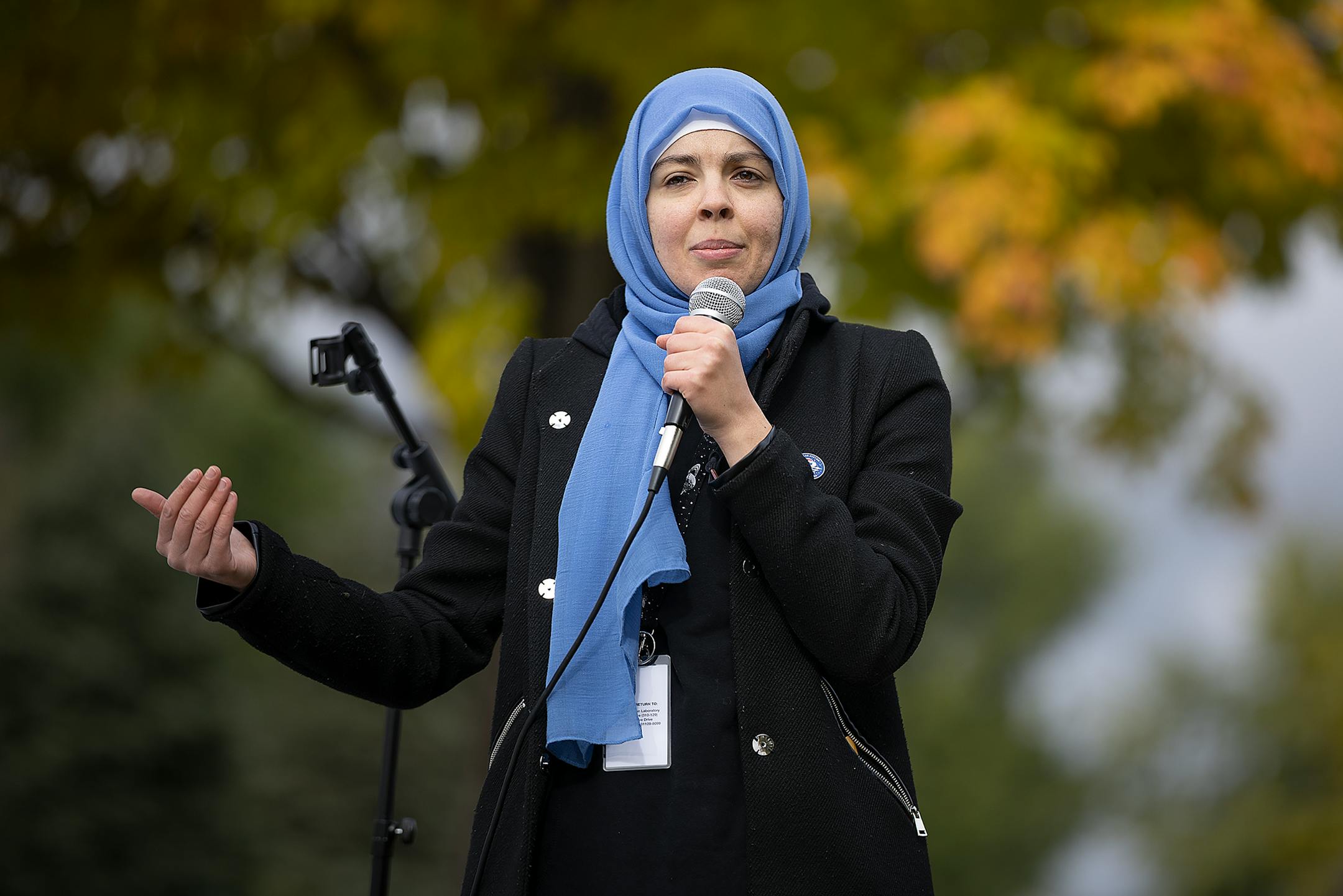 NASA/Jet Propulsion Laboratory Solar System Ambassador Nadia Abuisnaineh, cq, call people to prayer as they view the annular Eclipse during a viewing party at Commons Park in Fridley, Minn., on Saturday, Oct. 14, 2023.