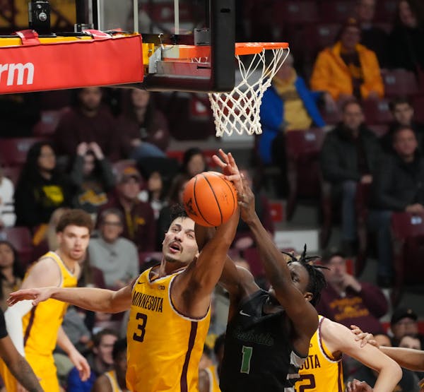 Gophers forward Dawson Garcia (3) beats out Chicago State Cougars guard Wesley Cardet Jr. (1) for a rebound in the second half at Williams Arena on De