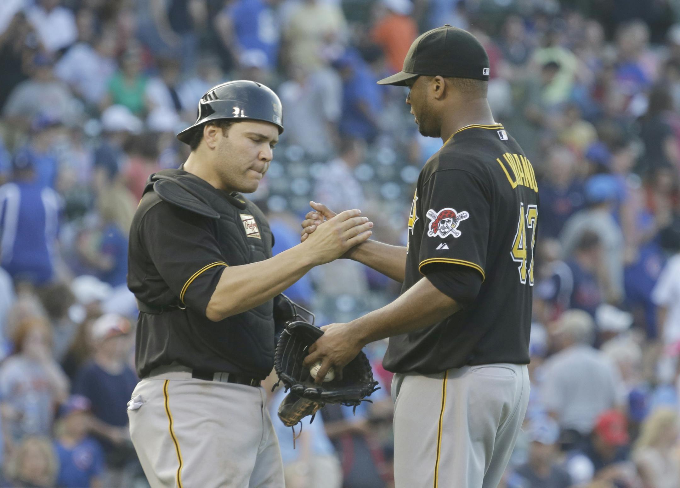 Pittsburgh Pirates catcher Russell Martin, left, celebrates with starter Francisco Liriano after the Pirates defeated the Chicago Cubs 6-2 in a baseball game in Chicago, Friday, July 5, 2013. (AP Photo/Nam Y. Huh)